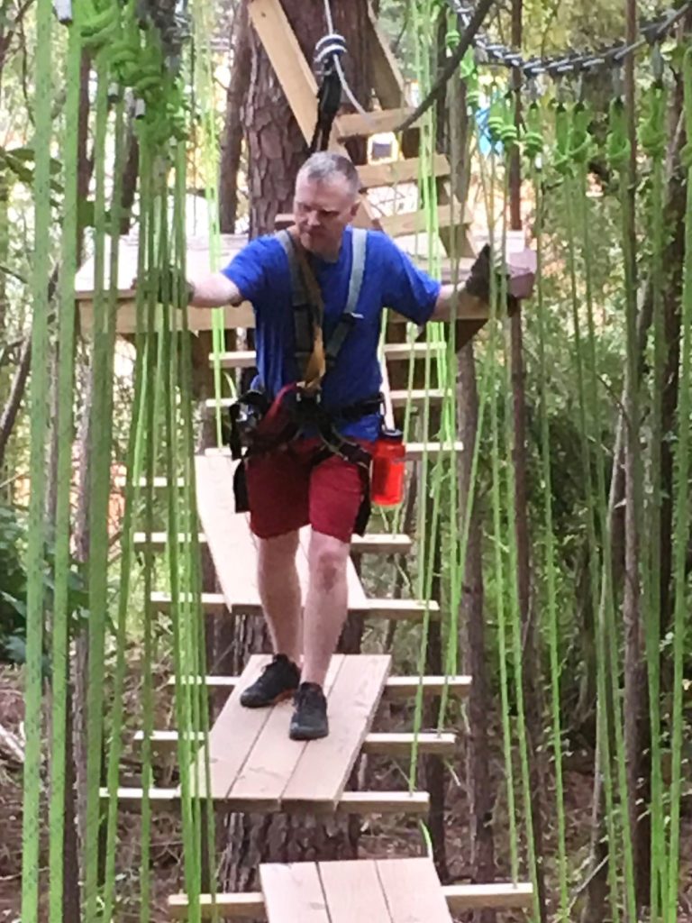 Balancing on the swinging bridge at TreeRunner Raleigh