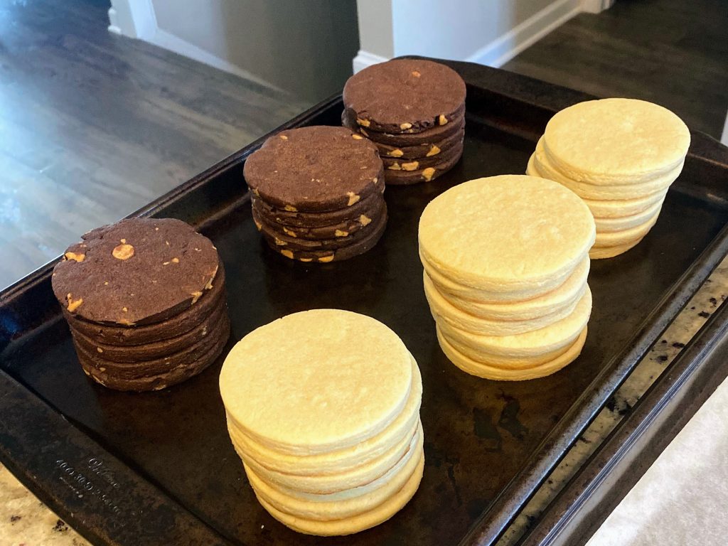 Stacks of chocolate and vanilla sugar cookies waiting to be decorated.