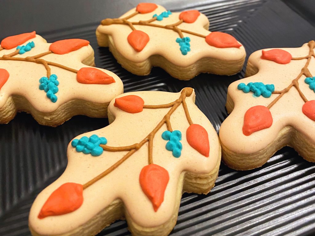 Leaf and stem cookies in teal, brown and orange showing cookie baking tips.