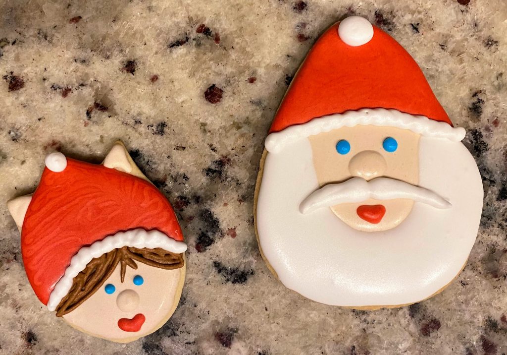 Sugar cookie Santa and elf on a granite counter