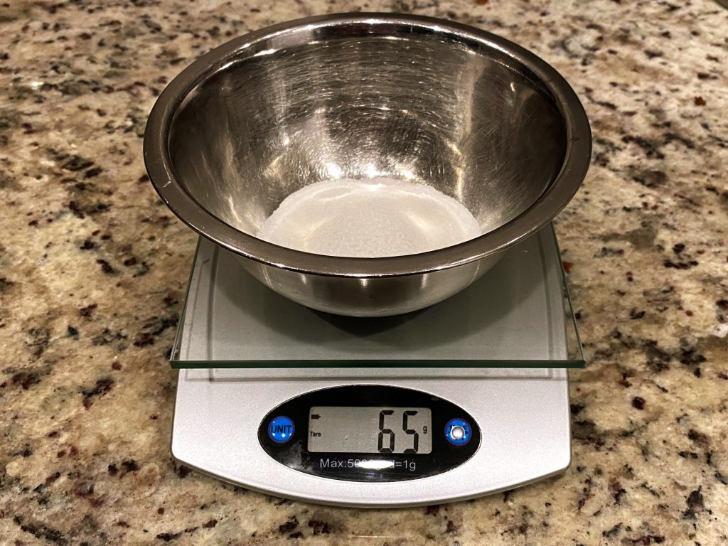 Kitchen scale with bowl of sugar, essential cookie baking tips!