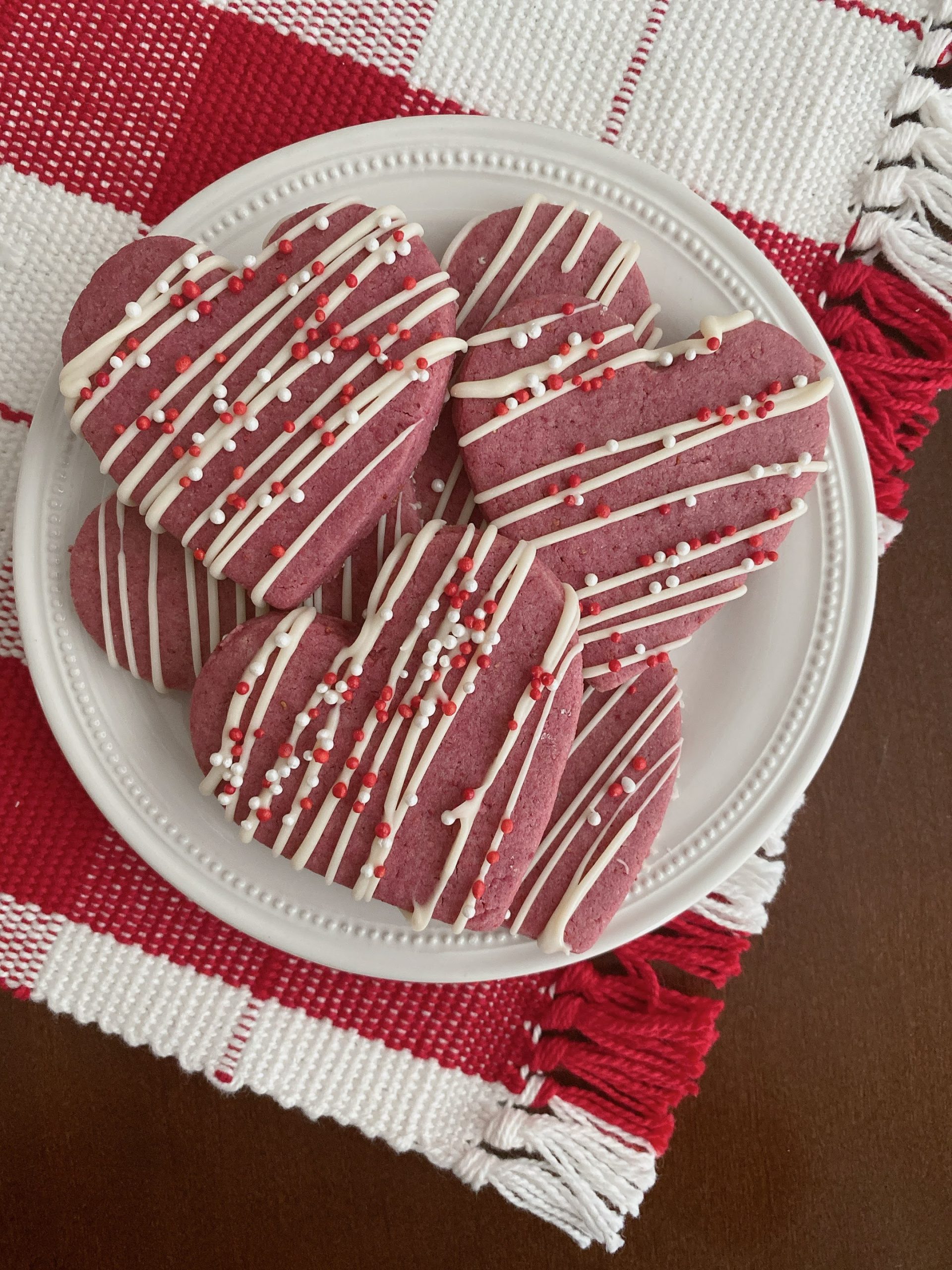 Raspberry sugar cookies made with freeze dried raspberry powder, and NO FOOD DYES! A flavorful sugar cookie perfect for Valentine's Day. Step by step instructions to bake the perfect cookies for your loved ones.