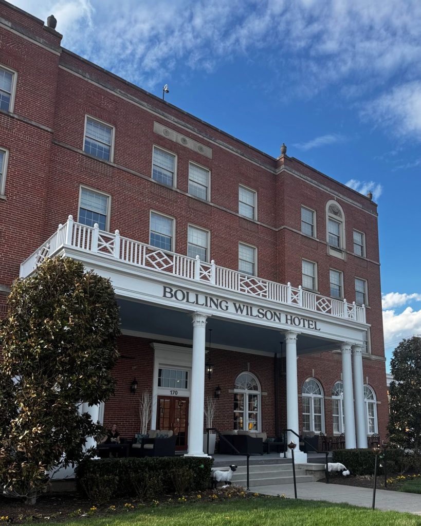 Front entrance of the Bolling Wilson Hotel with sheep alongside the front stairs.