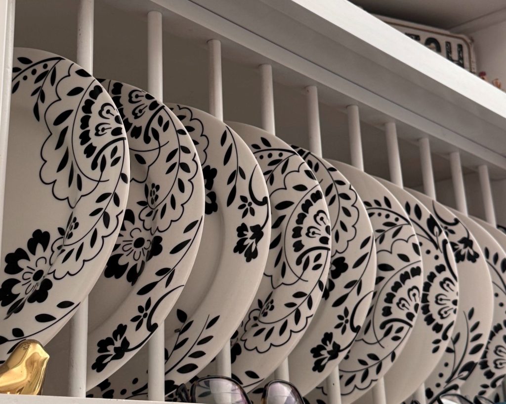 Dishes and other decor on a white shelf.