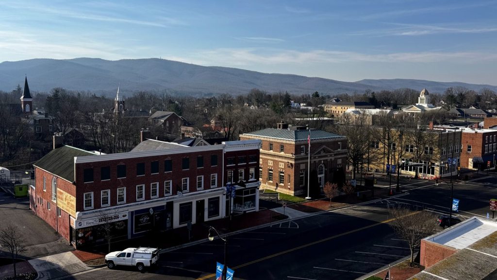 Downtown Wytheville Virginia with building spires in background and Blue Ridge Mountains behind that.